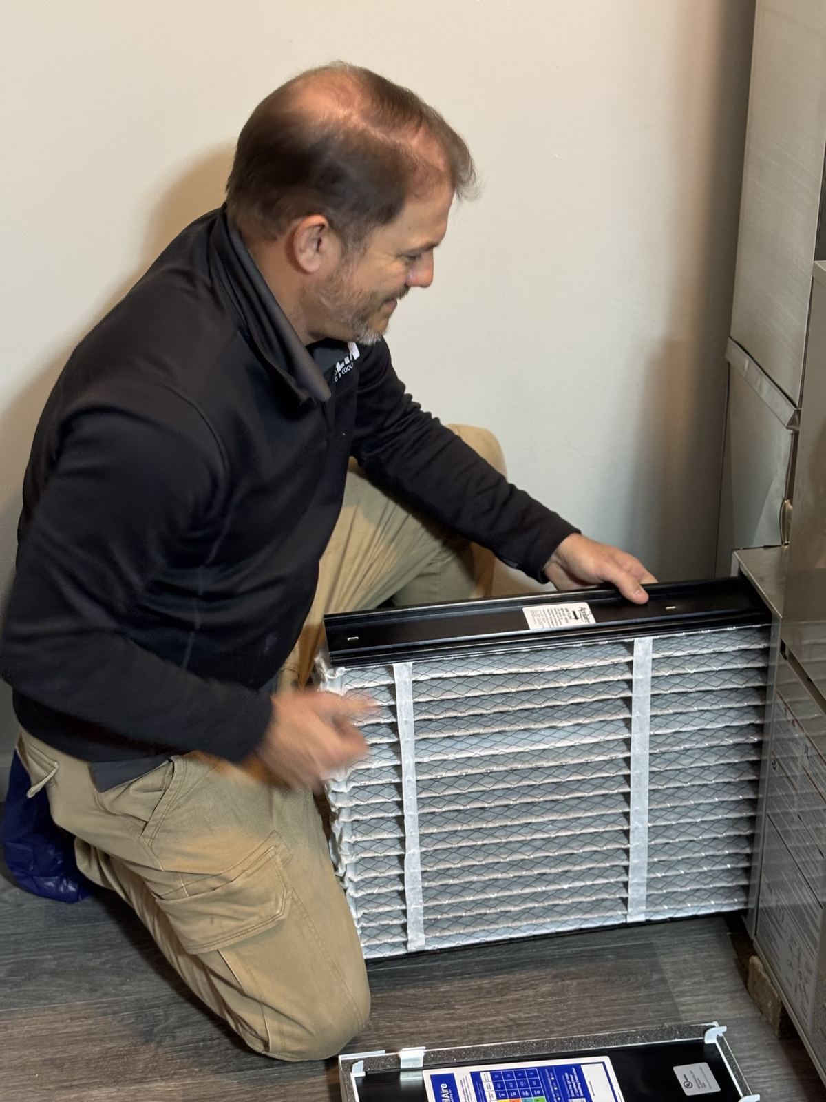 Delta T technician replacing an air filter