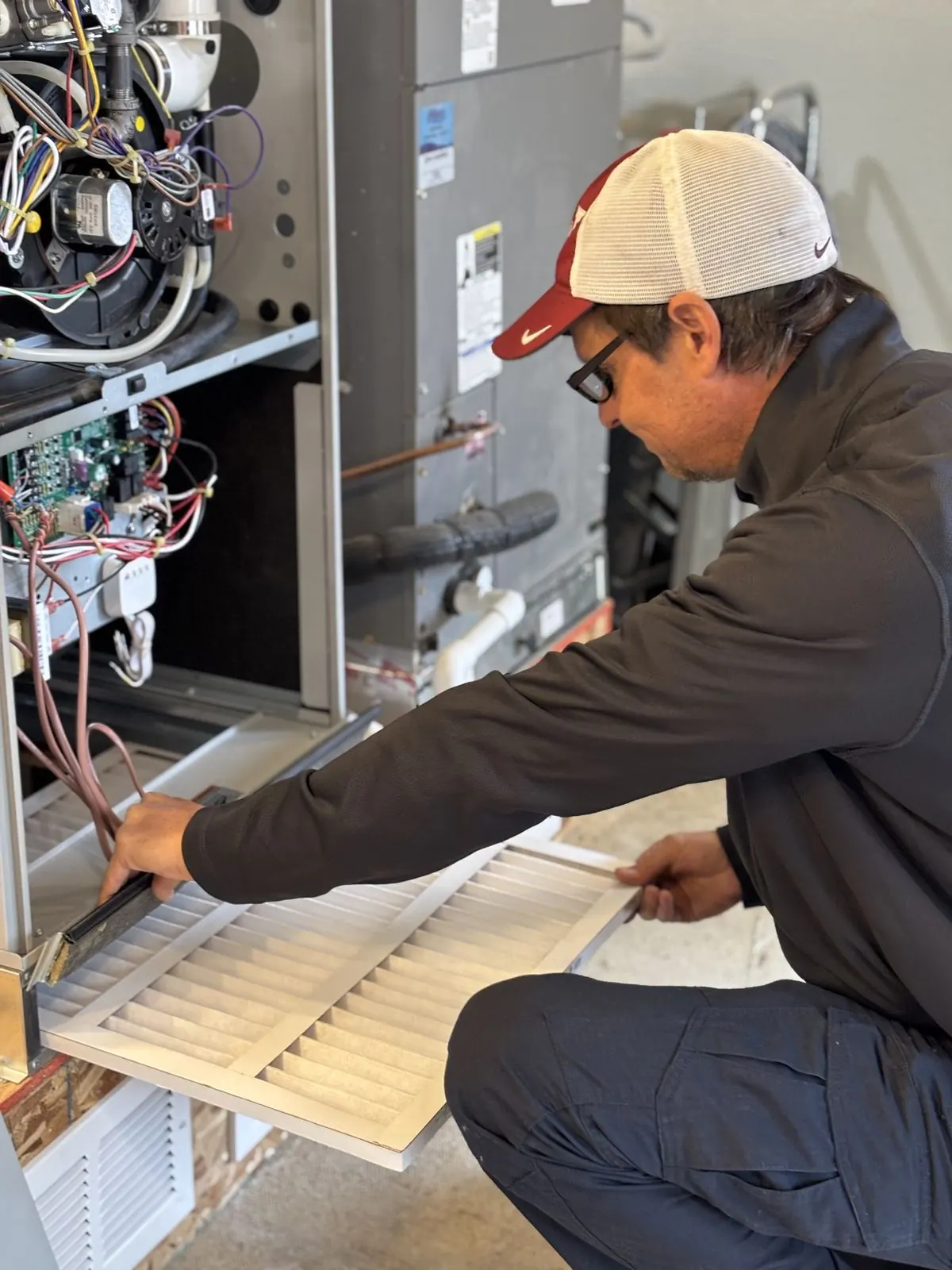 Delta T technician working on a heat pump system